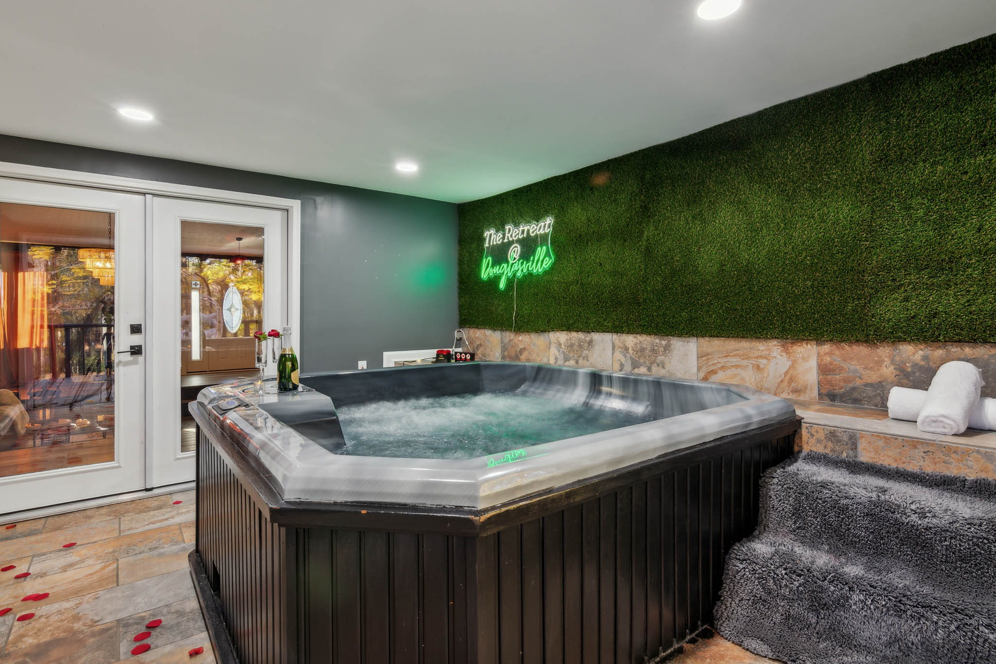 Hot tub with champagne and romantic decor, The Retreat at Douglasville